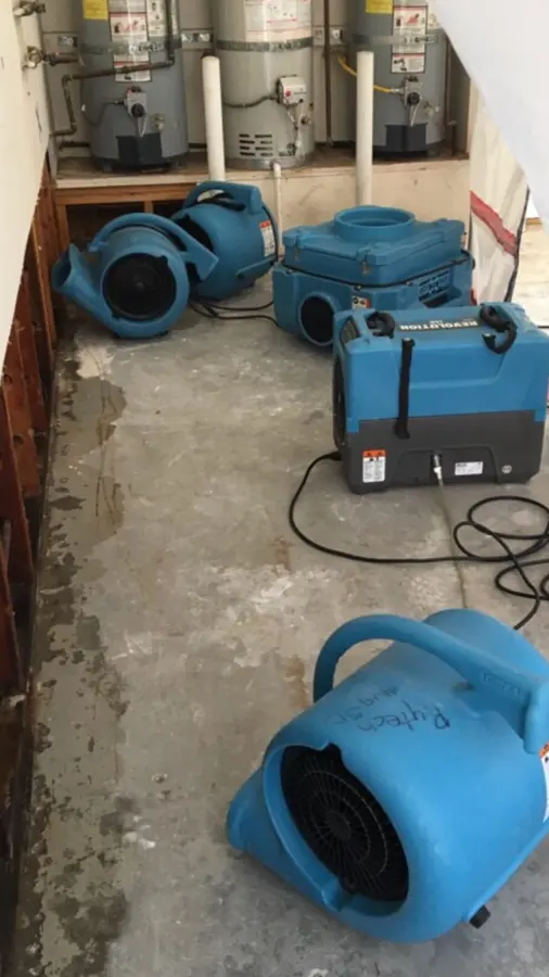 A row of air movers drying a wet floor in an Antioch, IL home